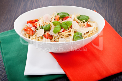 fresh tasty pasta spaghetti with tomatoes and basil