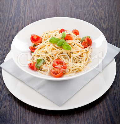 fresh tasty pasta spaghetti with tomatoes and basil