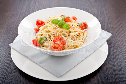 fresh tasty pasta spaghetti with tomatoes and basil