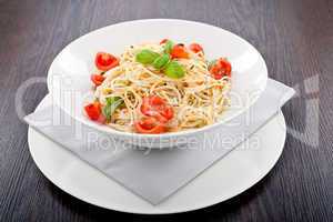 fresh tasty pasta spaghetti with tomatoes and basil