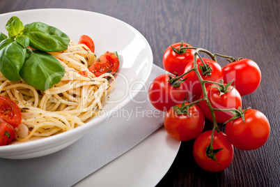 fresh tasty pasta spaghetti with tomatoes and basil