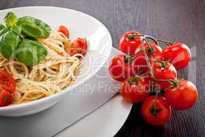 fresh tasty pasta spaghetti with tomatoes and basil