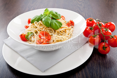 fresh tasty pasta spaghetti with tomatoes and basil