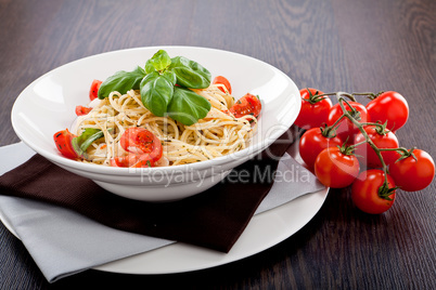 fresh tasty pasta spaghetti with tomatoes and basil