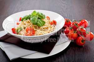 fresh tasty pasta spaghetti with tomatoes and basil