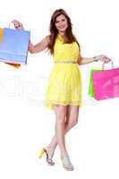 attractive young woman with colorful shopping bags isolated