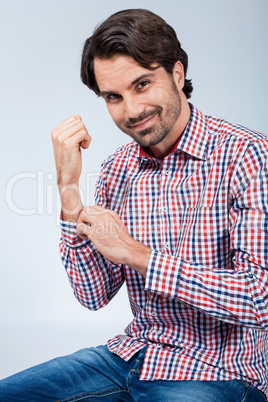 Handsome young man sitting on a wooden box