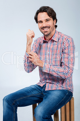 Handsome young man sitting on a wooden box