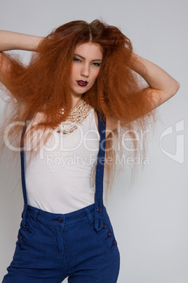 Female model playing with frizzy hair