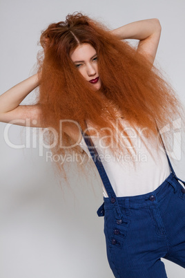 Female model playing with frizzy hair