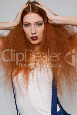 Female model playing with frizzy hair