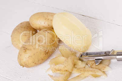 Potatoes with Peeler and Peeled Skin