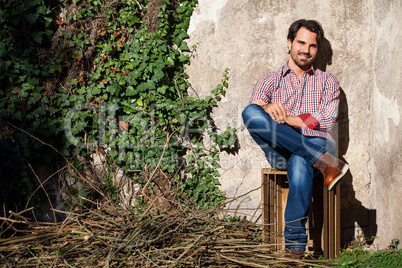 Male model sitting with legs crossed