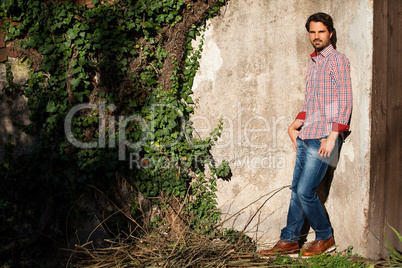 Male model leaning against wall