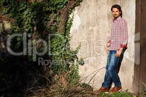 Male model leaning against wall