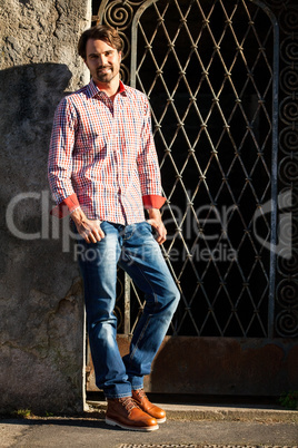 Male model leaning against wall