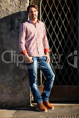 Male model leaning against wall