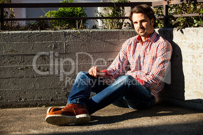 Man sitting on the ground with feet crossed