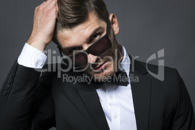 Handsome businessman adjusting his tie