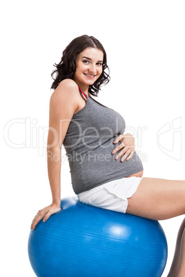 Pregnant woman doing pilates exercises