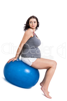 Pregnant woman doing pilates exercises