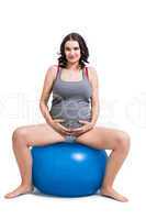 Pregnant woman doing pilates exercises