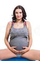 Pregnant woman doing pilates exercises