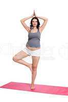 Active young pregnant woman doing yoga