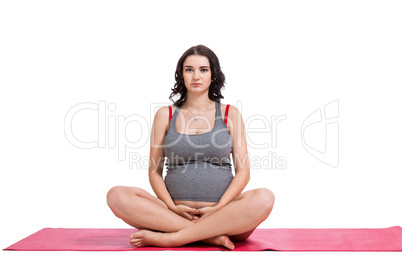 Pregnant woman practising yoga and meditating