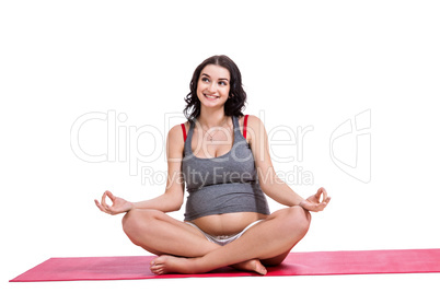 Pregnant woman practising yoga and meditating
