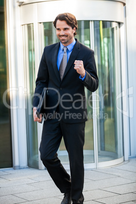 Motivated businessman punching the air