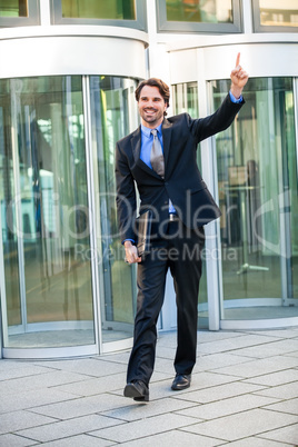 Motivated businessman punching the air