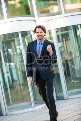 Motivated businessman punching the air