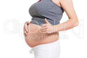Pregnant woman giving a thumbs up gesture