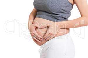 Young pregnant woman making a heart gesture