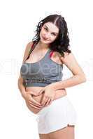 Young pregnant woman making a heart gesture