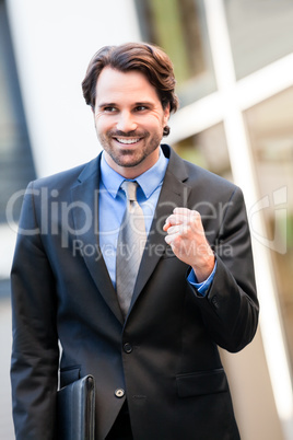 Motivated businessman punching the air