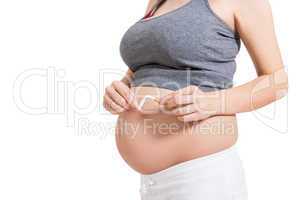 Pregnant woman breaking a cigarette in two