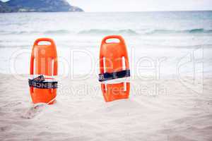 orange red life buoy in sand on beach at the sea object