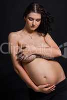 Pregnant woman posing nude