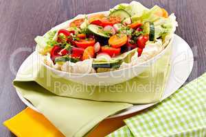 fresh mixed colorful salad on wooden table