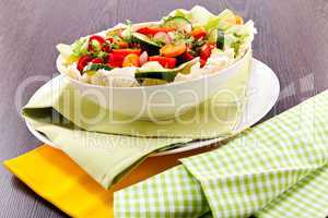 fresh mixed colorful salad on wooden table