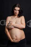 Pregnant woman posing nude