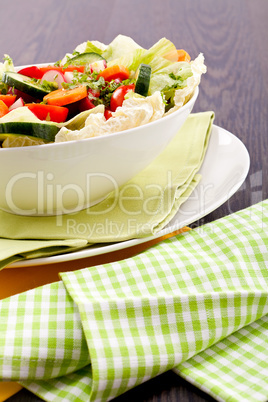 fresh mixed colorful salad on wooden table