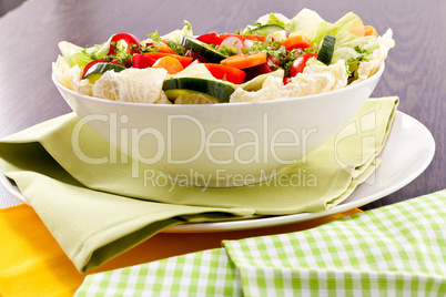 fresh mixed colorful salad on wooden table