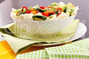 fresh mixed colorful salad on wooden table