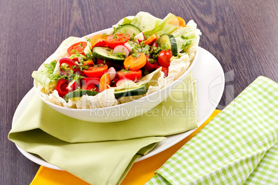 fresh mixed colorful salad on wooden table