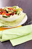 fresh mixed colorful salad on wooden table