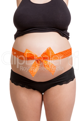 Pregnant woman wearing a bow on her belly