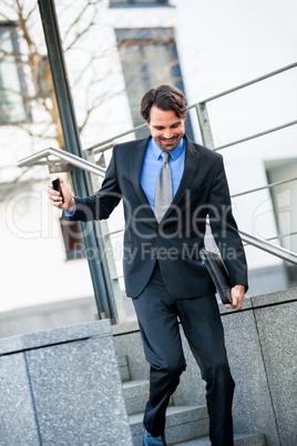 Smiling businessman walking down stairs